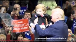 Trump holding up baby